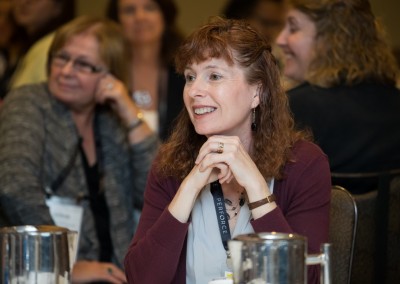 Woman sits at table at Women Who Test